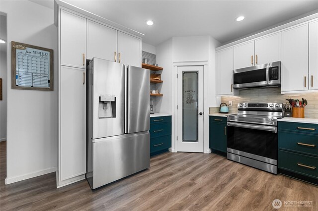 15315 91st Ave SE, Yelm, WA 98597 - kitchen with appliances with stainless steel finishes, light countertops, wood finished floors, open shelves, and recessed lighting