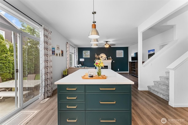 15315 91st Ave SE, Yelm, WA 98597 - kitchen with green cabinets, light wood-style floors, light countertops, and open floor plan