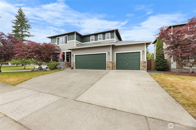 15315 91st Ave SE, Yelm, WA 98597 - view of front facade with stone siding, concrete driveway, an attached garage, and board and batten siding