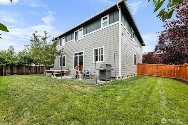 15315 91st Ave SE, Yelm, WA 98597 - rear view of house with board and batten siding, a patio, and a fenced backyard
