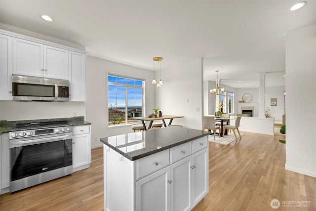 3421 Highfield Ct, Bellingham, WA 98226 - kitchen with appliances with stainless steel finishes, light wood-style floors, white cabinets, a chandelier, and recessed lighting