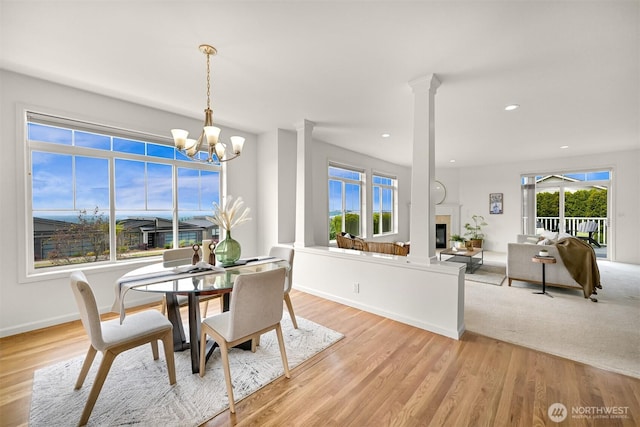 3421 Highfield Ct, Bellingham, WA 98226 - dining area featuring a chandelier, light wood finished floors, a glass covered fireplace, and recessed lighting