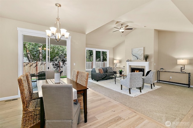 7391 Mirasett St SW Lot 42, Tumwater, WA 98512 - dining area featuring light wood-style floors, a chandelier, a fireplace, a ceiling fan, and baseboards