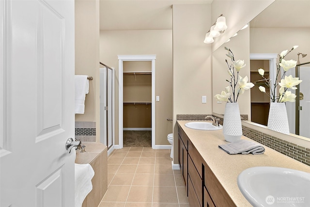 7391 Mirasett St SW Lot 42, Tumwater, WA 98512 - bathroom with a stall shower, tile patterned floors, double vanity, toilet, and a walk in closet