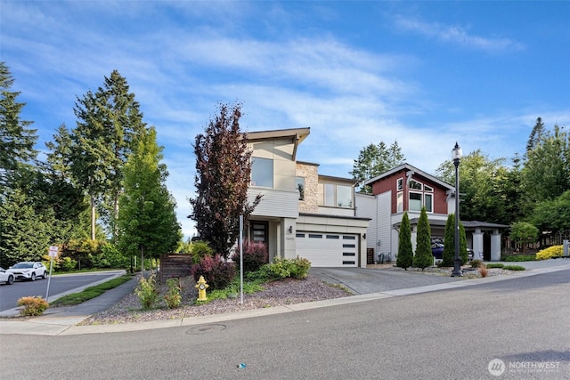 13695 NE 100th Ct, Kirkland, WA 98033 - contemporary house with a garage, asphalt driveway, and stucco siding