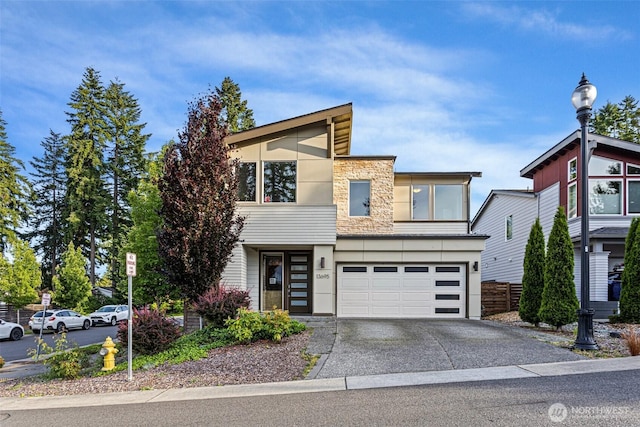 13695 NE 100th Ct, Kirkland, WA 98033 - contemporary home with stone siding, driveway, stucco siding, and a garage