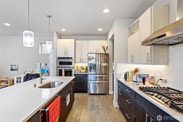 13695 NE 100th Ct, Kirkland, WA 98033 - kitchen with appliances with stainless steel finishes, wall chimney range hood, a sink, light countertops, and recessed lighting