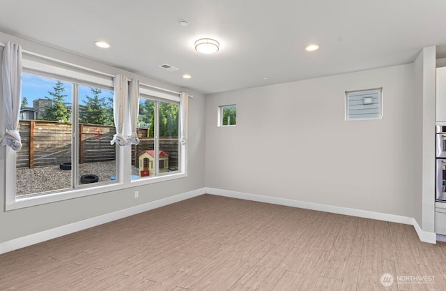 13695 NE 100th Ct, Kirkland, WA 98033 - unfurnished room with baseboards, light wood finished floors, and recessed lighting