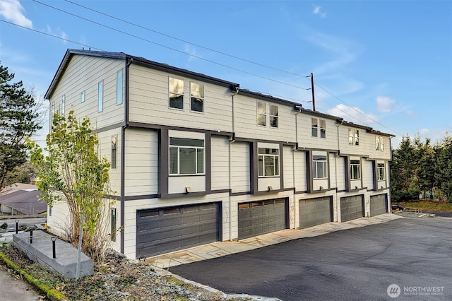 6726 NE 187th St Unit 102, Kenmore, WA 98028 - view of front of house featuring a garage and asphalt driveway
