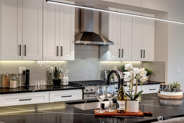 6726 NE 187th St Unit 102, Kenmore, WA 98028 - kitchen featuring wall chimney range hood, dark countertops, and white cabinets