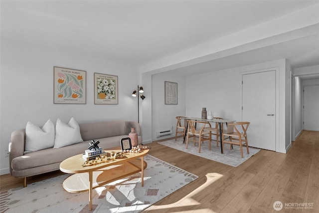 1601 Taylor Ave N Unit 303, Seattle, WA 98109 - living room featuring a baseboard heating unit, light wood finished floors, and baseboards