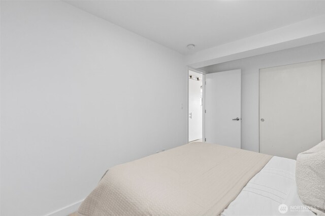 1601 Taylor Ave N Unit 303, Seattle, WA 98109 - bedroom with baseboards and a closet