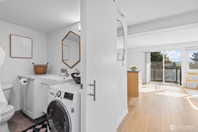 1601 Taylor Ave N Unit 303, Seattle, WA 98109 - washroom with washer / dryer and wood finished floors