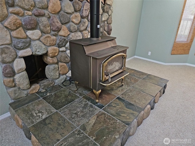 20025 Carper Rd SW, Rochester, WA 98579 - detailed view of baseboards, carpet, and a wood stove