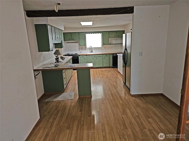 20025 Carper Rd SW, Rochester, WA 98579 - kitchen with green cabinets, stove, a sink, refrigerator with ice dispenser, and wood finished floors