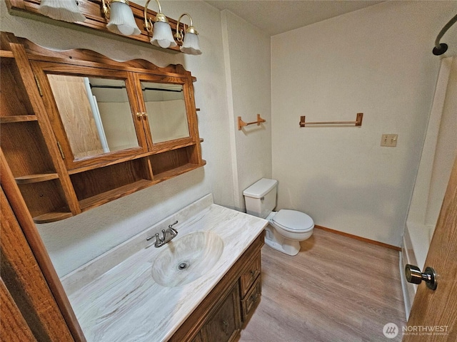 20025 Carper Rd SW, Rochester, WA 98579 - bathroom with vanity, toilet, wood finished floors, a shower, and baseboards