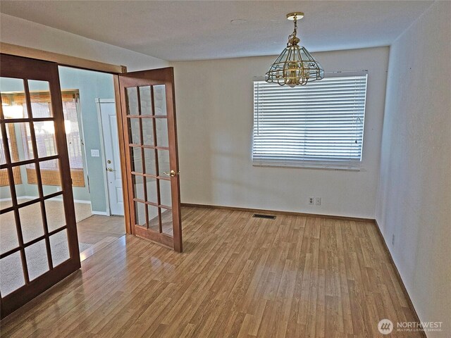 20025 Carper Rd SW, Rochester, WA 98579 - empty room with a chandelier, wood finished floors, and baseboards