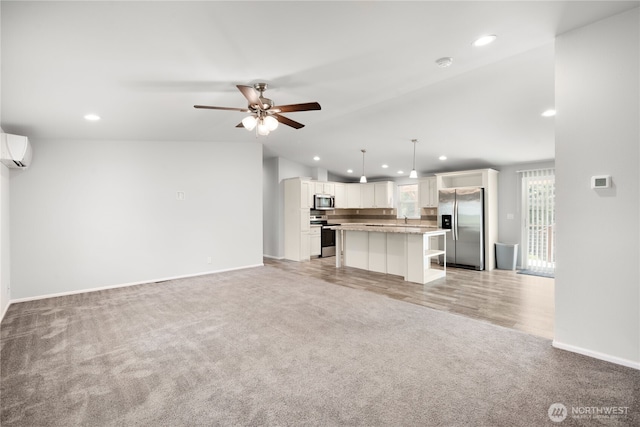 133 Broad St W, Bremerton, WA 98312 - unfurnished living room featuring light colored carpet, recessed lighting, a ceiling fan, a wall mounted AC, and lofted ceiling
