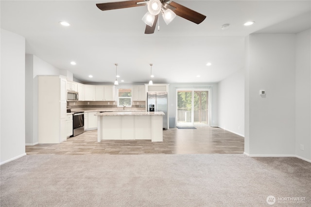 133 Broad St W, Bremerton, WA 98312 - kitchen featuring stainless steel appliances, open floor plan, light colored carpet, recessed lighting, and a ceiling fan