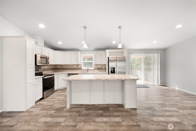 133 Broad St W, Bremerton, WA 98312 - kitchen featuring appliances with stainless steel finishes, a kitchen island, white cabinets, recessed lighting, and hanging light fixtures