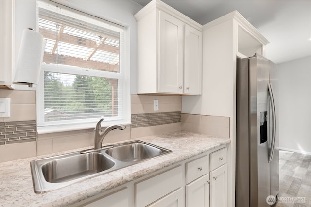 133 Broad St W, Bremerton, WA 98312 - kitchen with stainless steel fridge with ice dispenser, plenty of natural light, and white cabinets