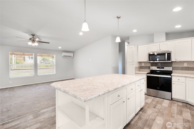133 Broad St W, Bremerton, WA 98312 - kitchen with appliances with stainless steel finishes, a wall unit AC, light wood-type flooring, tasteful backsplash, and open floor plan