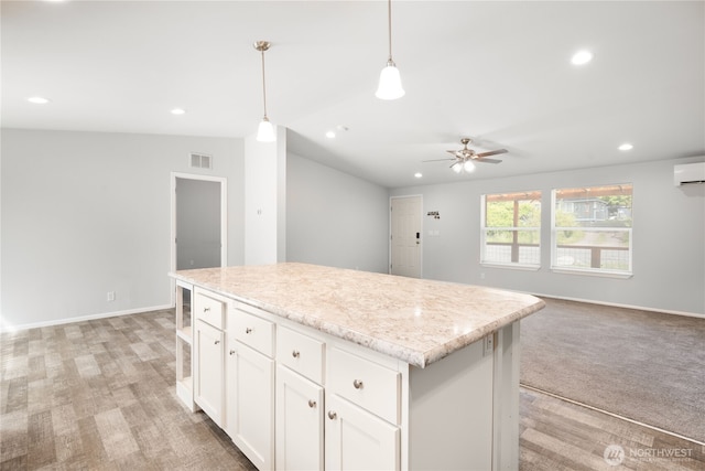 133 Broad St W, Bremerton, WA 98312 - kitchen featuring a center island, open floor plan, white cabinets, a ceiling fan, and pendant lighting