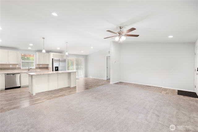 133 Broad St W, Bremerton, WA 98312 - kitchen with stainless steel appliances, open floor plan, light colored carpet, recessed lighting, and a center island