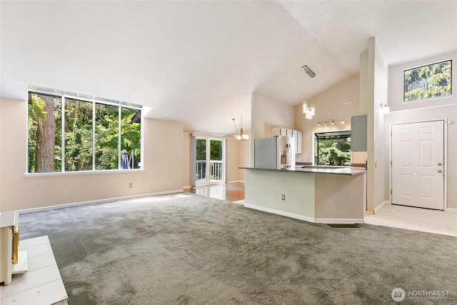 10008 50th Pl W, Mukilteo, WA 98275 - unfurnished living room featuring a chandelier, light colored carpet, and high vaulted ceiling