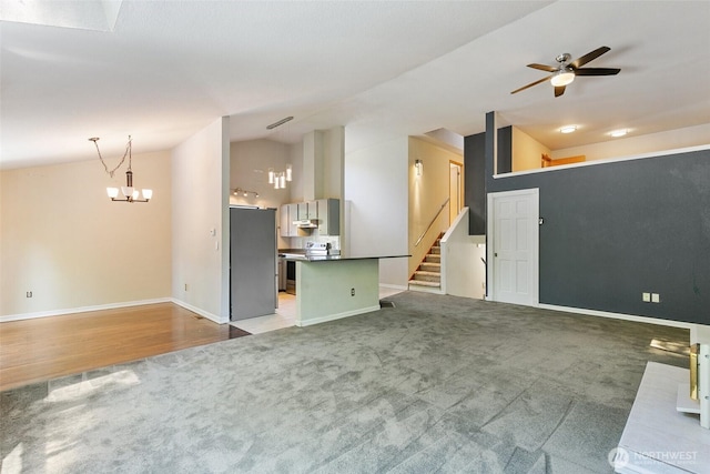 10008 50th Pl W, Mukilteo, WA 98275 - unfurnished living room with carpet floors, vaulted ceiling, a ceiling fan, a chandelier, and stairs