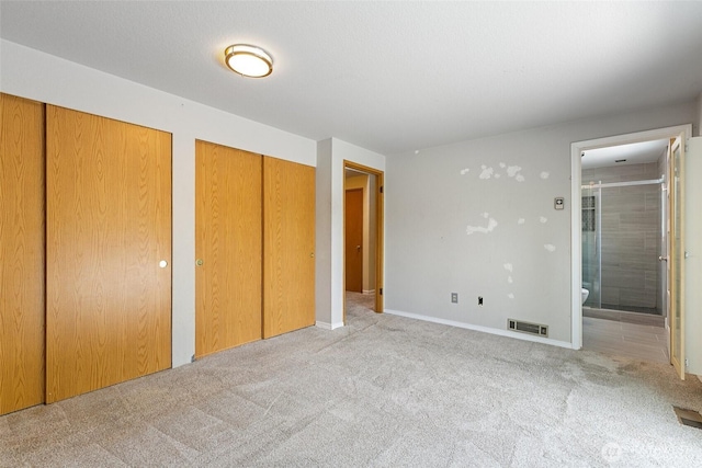 10008 50th Pl W, Mukilteo, WA 98275 - unfurnished bedroom featuring two closets, carpet floors, and connected bathroom