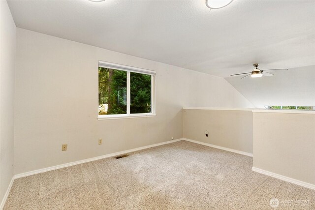 10008 50th Pl W, Mukilteo, WA 98275 - spare room featuring carpet floors, a ceiling fan, and lofted ceiling