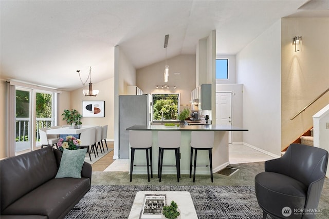 10008 50th Pl W, Mukilteo, WA 98275 - living area featuring lofted ceiling, stairs, and wood finished floors