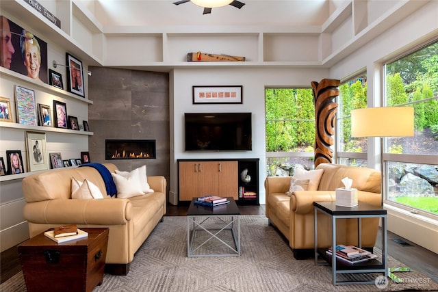 11116 SE 4th St, Bellevue, WA 98004 - living room with wood finished floors, healthy amount of natural light, a tiled fireplace, and ceiling fan