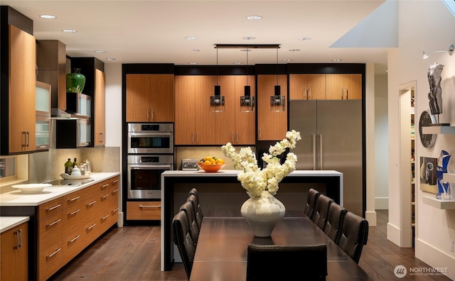 11116 SE 4th St, Bellevue, WA 98004 - kitchen featuring appliances with stainless steel finishes, brown cabinetry, light countertops, dark wood-style floors, and recessed lighting