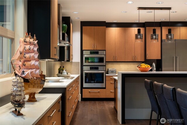 11116 SE 4th St, Bellevue, WA 98004 - kitchen with appliances with stainless steel finishes, brown cabinets, light countertops, and dark wood finished floors