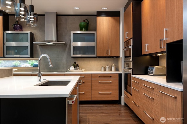 11116 SE 4th St, Bellevue, WA 98004 - kitchen with wall chimney exhaust hood, light countertops, brown cabinetry, and recessed lighting