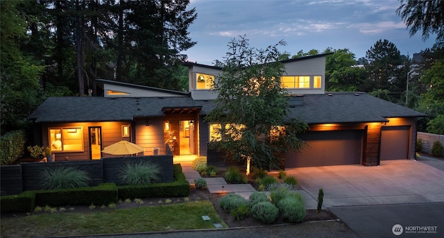 11116 SE 4th St, Bellevue, WA 98004 - modern home featuring driveway, a garage, a fenced front yard, and roof with shingles