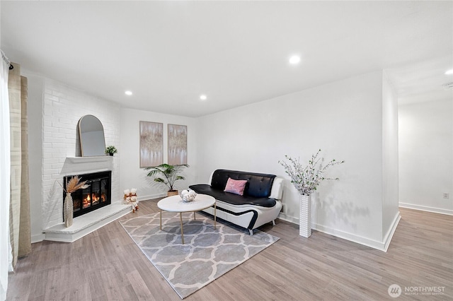 4721 176th St SW Unit G7, Lynnwood, WA 98037 - living room featuring a fireplace, wood finished floors, recessed lighting, and baseboards