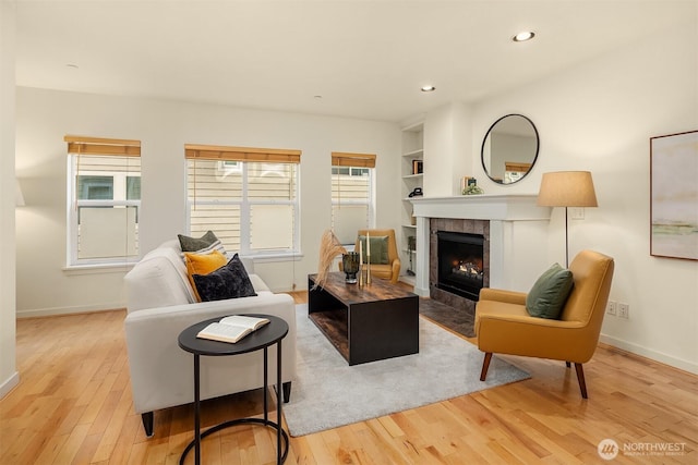 7321 47th Ave SW Unit B, Seattle, WA 98136 - living room featuring light wood-style floors, baseboards, a tile fireplace, built in shelves, and recessed lighting