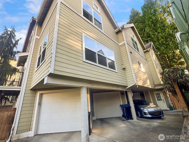 7321 47th Ave SW Unit B, Seattle, WA 98136 - view of side of property featuring an attached garage and driveway