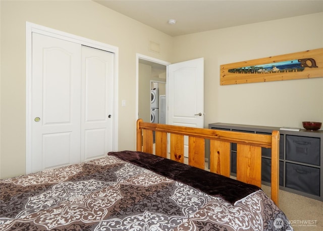 155 Triopha Ln, Sequim, WA 98382 - bedroom with stacked washing machine and dryer, a closet, and carpet
