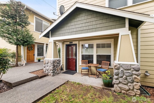 5907 40th Ave SW Unit B, Seattle, WA 98136 - doorway to property featuring covered porch and stone siding
