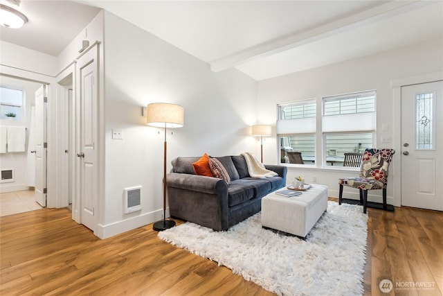 5907 40th Ave SW Unit B, Seattle, WA 98136 - living area featuring light wood-style flooring, beam ceiling, baseboards, and heating unit
