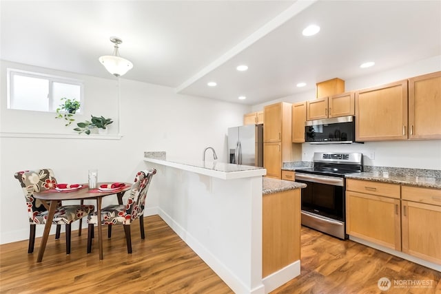 5907 40th Ave SW Unit B, Seattle, WA 98136 - kitchen featuring appliances with stainless steel finishes, a peninsula, light wood-type flooring, recessed lighting, and light brown cabinets