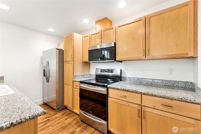 5907 40th Ave SW Unit B, Seattle, WA 98136 - kitchen featuring appliances with stainless steel finishes, light brown cabinetry, light wood-style flooring, recessed lighting, and a sink