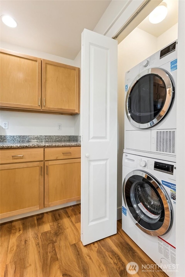 5907 40th Ave SW Unit B, Seattle, WA 98136 - washroom featuring estacked washer and dryer and light wood-style flooring