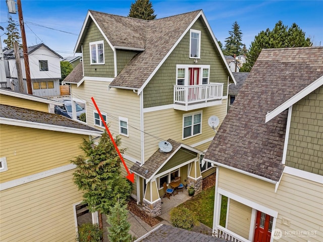 5907 40th Ave SW Unit B, Seattle, WA 98136 - view of side of property featuring a patio, roof with shingles, and a balcony