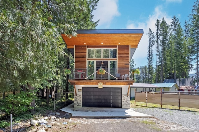 118 Silver Tip Ln, Packwood, WA 98361 - view of front of home with dirt driveway, an attached garage, and stone siding