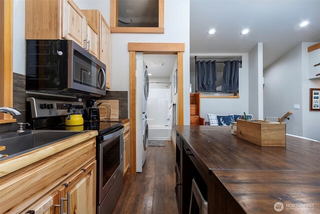 118 Silver Tip Ln, Packwood, WA 98361 - kitchen featuring appliances with stainless steel finishes, wooden counters, stacked washer / drying machine, recessed lighting, and dark wood-style flooring